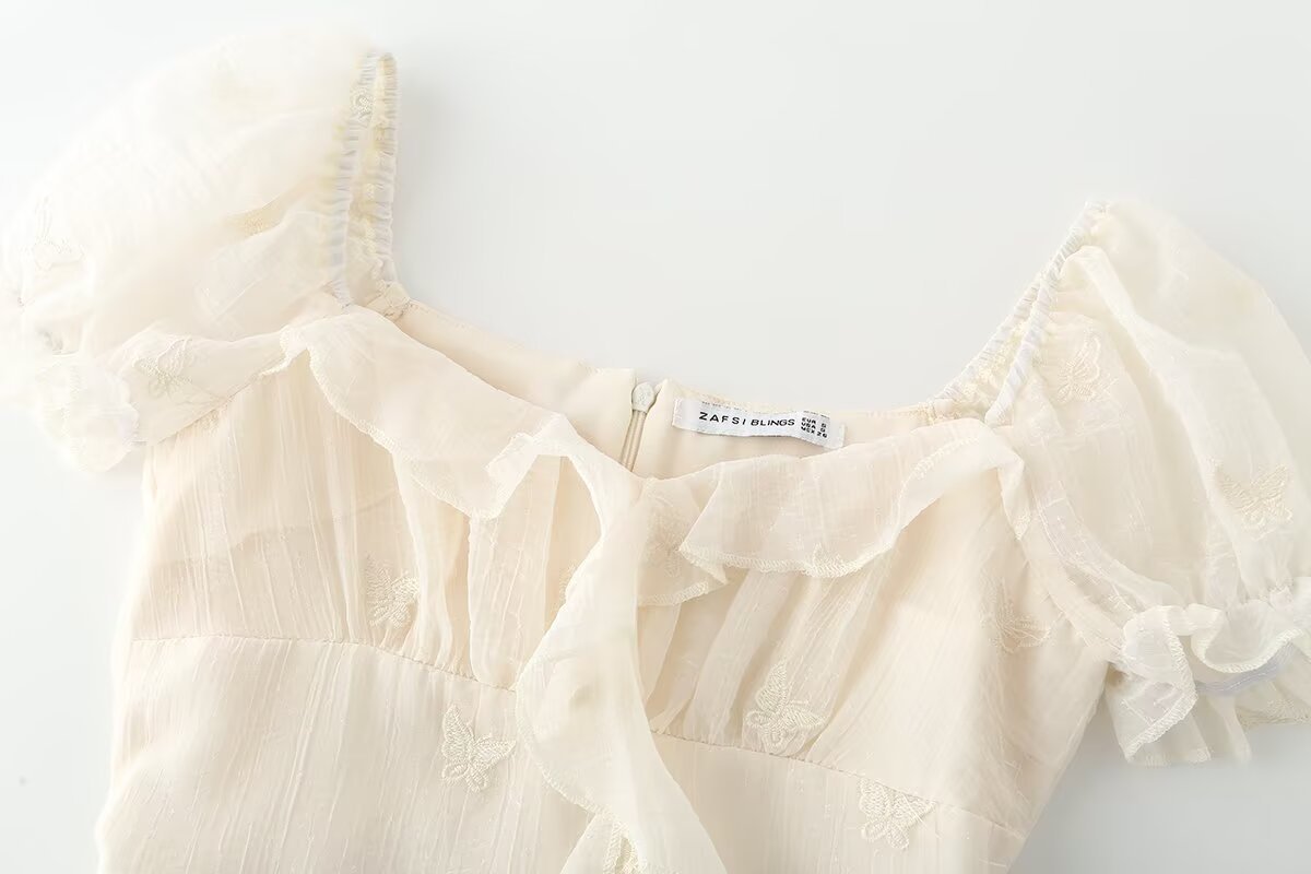 Irregular short sleeved dress with ruffled edges